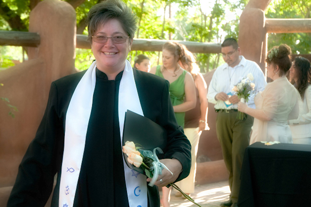 smiling minister w rose and folder